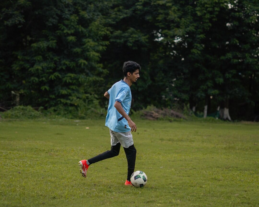 teen boy practicing football skills